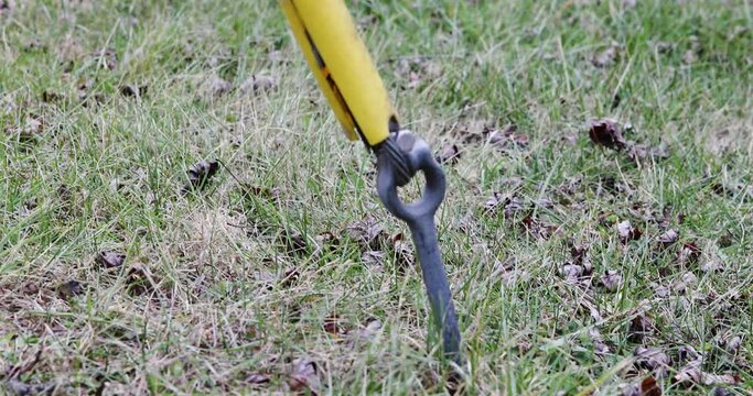 Shot of a moving ground guy wire anchor connecting to a distribution pole moving in the wind and yellow visibility cover. 4k