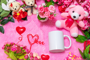 White blank coffee mug on the top of a fluffy pink carpet surrounded by valentine themed decorations