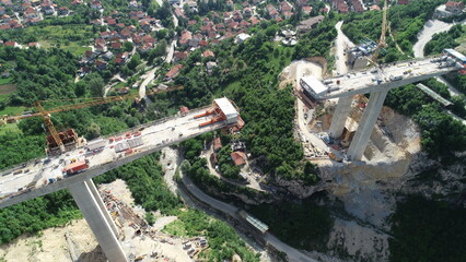 Aerial drone view on highway bridge road under construction. Construction of the viaduct on the...