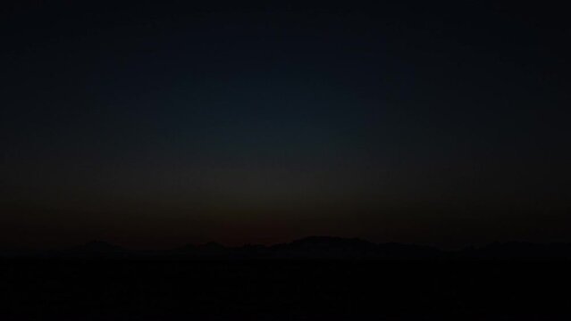 Beautiful clear big sun at sunrise or sunset against the backdrop of mountains. Africa. 4K. Time lapse
