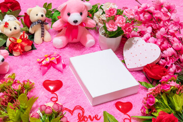 White blank rectangle box above a fluffy pink carpet surrounded by valentine themed decorations