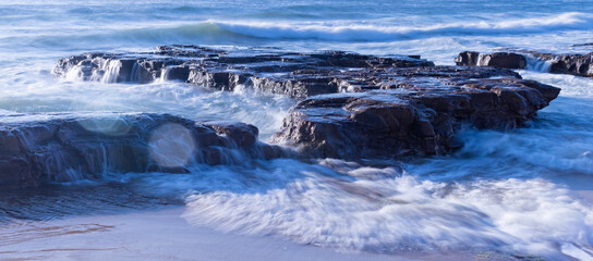 time lapse of waves over sea rocks