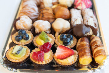 Assortment of delicious and colorful pastries, made by pastry chef. All look tasty and delightful. Perfect for a party. Natural light