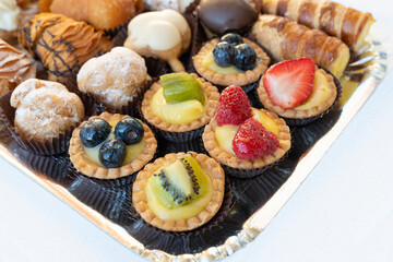 Assortment of delicious and colorful pastries, made by pastry chef. All look tasty and delightful. Perfect for a party. Natural light