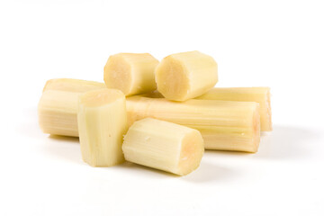 fresh sugarcane with cut pieces isolated on white background.