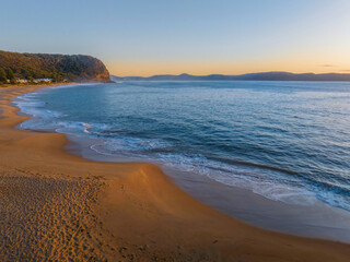 Aerial sunrise seascape with calm seas and a clear sky