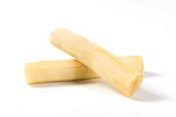 fresh sugarcane with cut pieces isolated on white background.