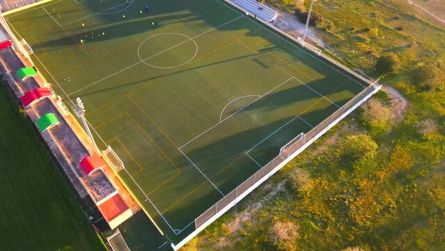 360 degrees rotating shot of a football field during golden hour in Santa Ponsa, Mallorca, Spain.