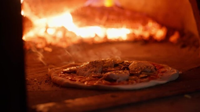Italian pizza is cooked in a wood-fired oven.