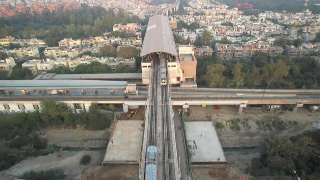 Aerial Drone Footage of Delhi Metro Train Station  Mayur Vihar Intersection highway with traffic Indian Flag 