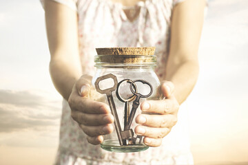 woman keeps the keys in a closed container, concept of freedom, knowledge, discovery, solution; progress, love