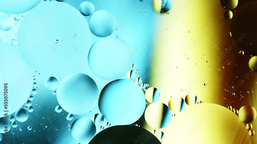 Aufkleber real close up oil bubbles in water rotation with color gradient abstract mixing background.