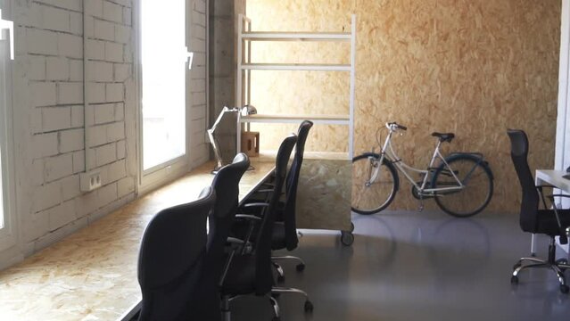 Shot of a working space with multiple empty seats and a bike parked in the back