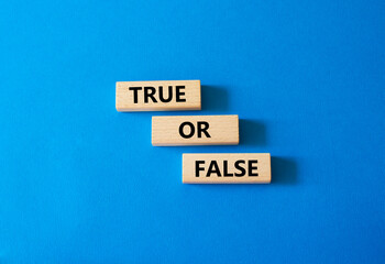 True or false symbol. Wooden blocks with words True or false. Beautiful white background. Businessman hand. Business concept and True or false. Copy space.