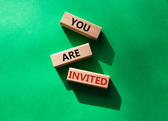 You are invited symbol. Wooden blocks with words You are invited. Beautiful green background. Business and You are invited concept. Copy space.