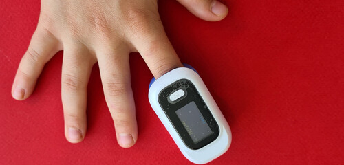 Pulse oximeter on child finger to measure pulse rate and oxygen levels