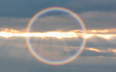 Halo is an optical phenomenon that belongs to the  ice-crystal halos - Circular rainbow cloud with...
