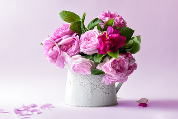 Pink roses in a white vase ,Spring greeting card.Bulgarian Damascena Rose