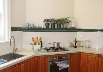 Lived in Kitchen stove top, oven and sink with timber cabinets