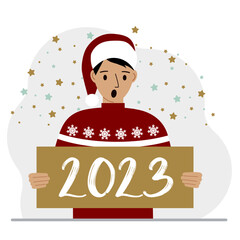 A man in a red sweater and with a cap holds a sign or poster with the numbers 2023. Postcard or greeting Merry Christmas and Happy New Year.