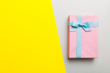 holiday handmade paper present tied blue ribbon bow top view with copy space. Flat lay holiday background. Birthday or christmas present. Christmas gift box concept with copy space