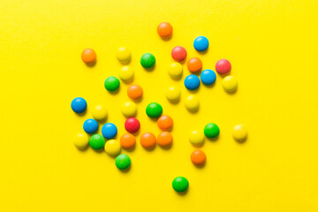 Mixed collection of colorful candy, on colored background. Flat lay, top view. frame of colorful chocolate coated candy