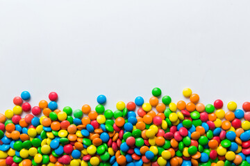 Mixed collection of colorful candy, on colored background. Flat lay, top view. frame of colorful chocolate coated candy