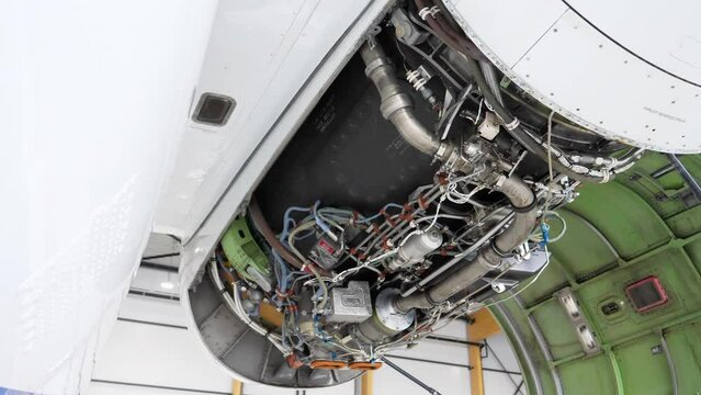 Airplane Jet Engine with Open Cover in Maintenance Hangar, Tilt Up.