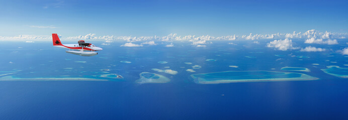 Seaplane flies over Maldives island