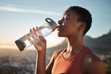 Water, hydration and black woman running in nature, fitness rest and health for exercise in Turkey. Energy, break and training African runner drinking water for body detox during an outdoor workout