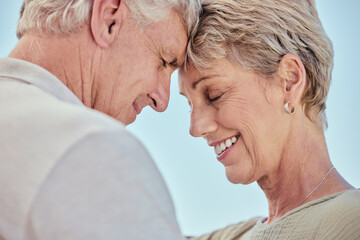 Love, nature and senior couple intimate, embrace and faces together with blue sky outdoors....