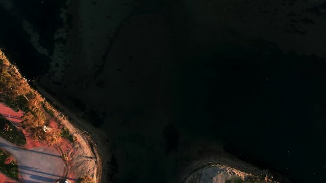 Aerial Tilt View Of Inciralti Lagoon With Red Pedestriand Bridge And Uckuyular, Izmir