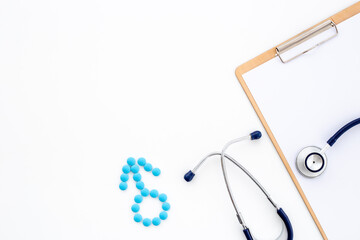 Male sign made of blue pills with doctor clipboard