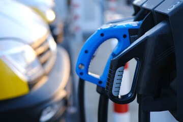 close-up of black and blue adapter with electric vehicle cables, replenish battery charging station, alternative energy development concept, electric vehicle production, electric energy storage