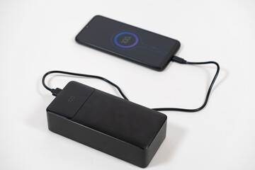 Connecting a mobile phone to a power bank. Charging gadgets from power banks.