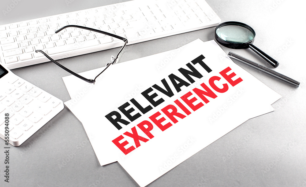 Poster relevant experience text on a paper with keyboard, calculator on grey background