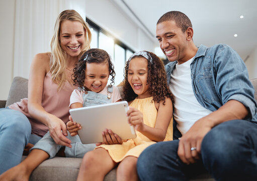 Love, sofa and family with kids, tablet or social media for streaming, interracial or laugh together. Digital, father or mother with female children, device or watch funny videos and happy parents