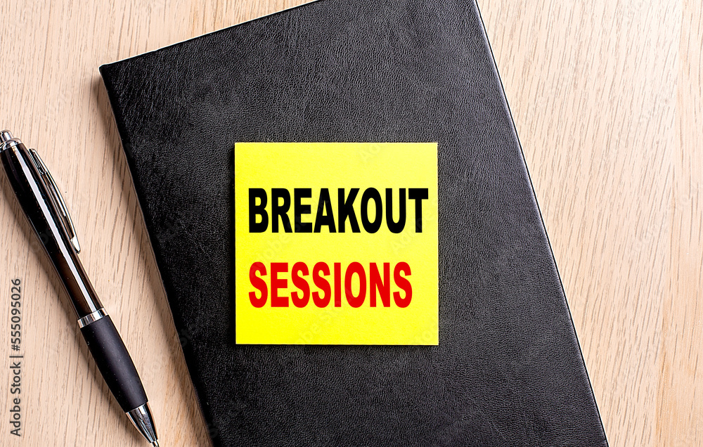 Poster breakout sessions text on a sticky on black notebook with pen