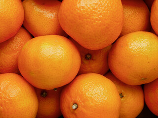 Close up of pile of juicy fresh mandarins or tangerine.