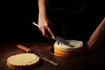 spreading cream on cake biscuit