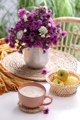 Fototapeta na wymiar Cup of aromatic coffee and beautiful flowers on white table