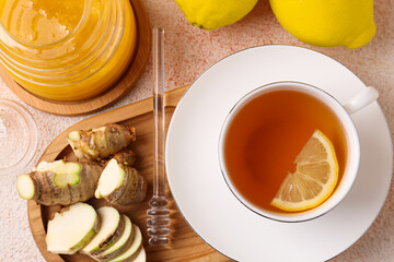 Tea, honey, lemon and ginger on beige textured table, flat lay