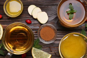 Flat lay composition of tea with honey and ingredients on wooden table