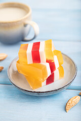 Almond milk and peach jelly on blue. side view, selective focus