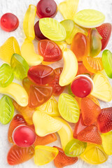 Various fruit jelly candies on gray concrete background. close up, top view.