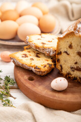 Homemade easter pie with raisins and eggs on plate on a white wooden background. side view, close up, selective focus.