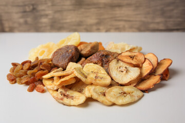 Pile of different dried fruits on white background