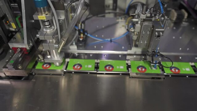 Hot Foil Stamping Machine Printing Cards In Printing Press Factory. closeup, zoom-out