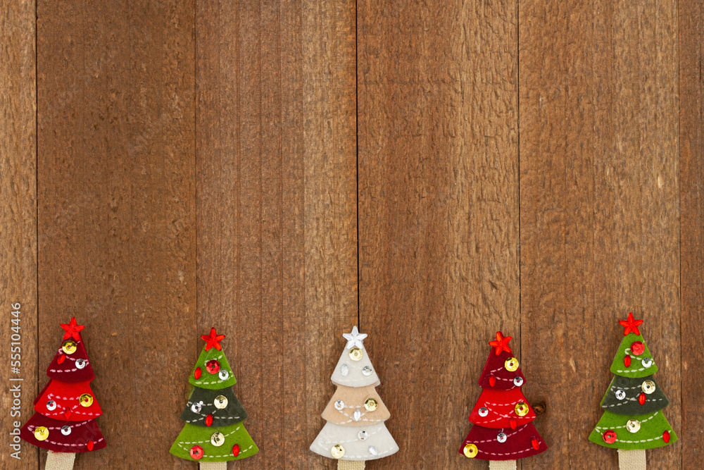 Wall mural Christmas trees on weathered wood holiday background - Wall murals