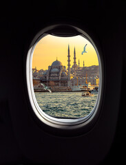 Istanbul sunset in old city with mosque, minarets and passenger ships, view from a porthole window of airplane. Concept for travel agency,  airline company or passenger transportation in Turkey.